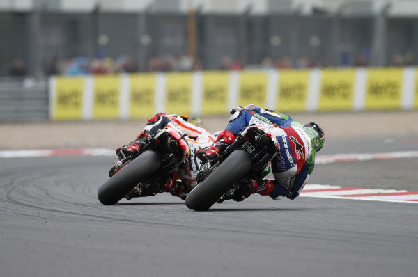 2014 MotoGP Championship 
British Grand Prix. 
Silverstone, England. 29th - 30st August 2014. 
Scott Redding, Gresini Honda, follows Marc Marquez, Honda, through Woodcote corner. 
Ref: _W7_8371. World copyright: Kevin Wood/LAT Photographic