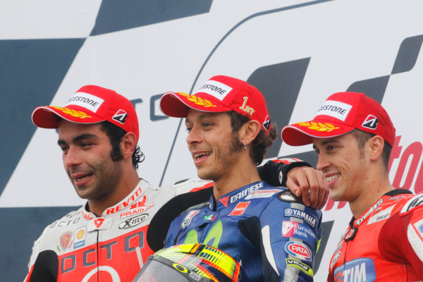 2015 MotoGP Championship. 
British Grand Prix. 
Silverstone, England. 28th - 30th August 2015. 
Danilo Petrucci, Pramac Ducati, 2nd position, Valentino Rossi, Yamaha, 1st position, and Andrea Dovizioso, Ducati, 3rd position, celebrate on the podium. 
Ref: KW7_8409a. World copyright: Kevin Wood/LAT Photographic