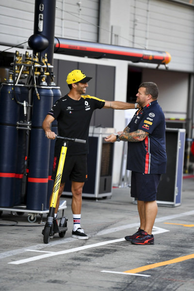 Daniel Ricciardo, Renault F1 Team plays on a scooter in the pit lane