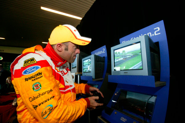 2003 Australian V8 Supercars, Round 9, Sandown, 14th September 2003.
David Brabham tries his hand on the PS2 during the Betta Electrical 500 held at Sandown International Raceway Melbourne, Australia this weekend.
Photo: Mark Horsburgh/LAT Photographic