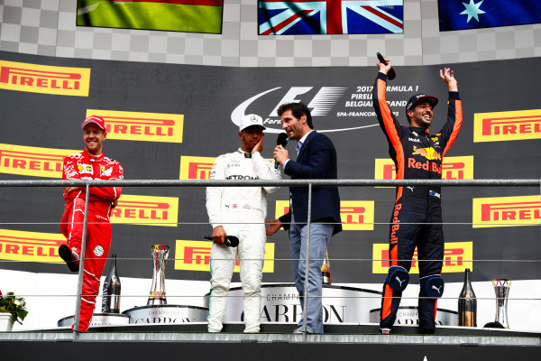 Spa Francorchamps, Belgium. 
Sunday 27 August 2017.
Mark Webber, Channel 4 F1, interviews winner Lewis Hamilton, Mercedes AMG, 1st Position, on the podium alongside Sebastian Vettel, Ferrari, 2nd Position, and Daniel Ricciardo, Red Bull Racing, 3rd Position.
World Copyright: Sam Bloxham/LAT Images 
ref: Digital Image _J6I0285