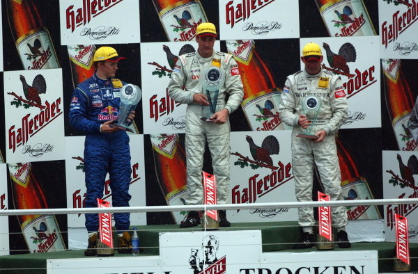 DTM Championship 2002, Round 10 - Hockenheimring, Germany, 6 October 2002 - Podium of the last race of the 2002 season. 1st: Bernd Schneider (GER),Vodafone AMG-Mercedes, centre; 2nd: Mattias Ekstrom (SWE), Team Abt, left; 3rd: Uwe Alzen (GER), Warsteiner AMG-Mercedes, right.
DTM Championship, Rd10, Hockenheim, Germany. 06 October 2002.
DIGITAL IMAGE