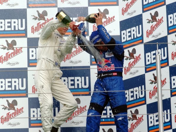 (L-R) Alexander Margaritis (GRE) Weigl Motorsport 2nd (later disqualified) celebrates with champagne on the podium with race winner Christian Klien (AUT) JD Motorsport.
German Formula Renault Championship, Rd6, Races 11 and 12, Nurburgring, Germany. 22 September 2002.
DIGITAL IMAGE