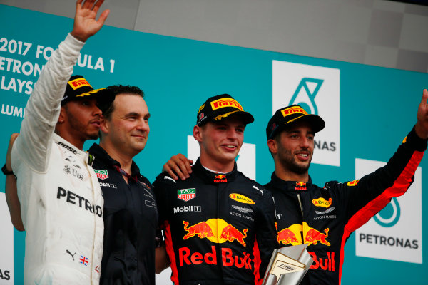 Sepang International Circuit, Sepang, Malaysia.
Sunday 01 October 2017.
Lewis Hamilton, Mercedes AMG, winner Max Verstappen, Red Bull Racing and Daniel Ricciardo, Red Bull Racing wave on the podium.
World Copyright: Andy Hone/LAT Images 
ref: Digital Image _ONY5377