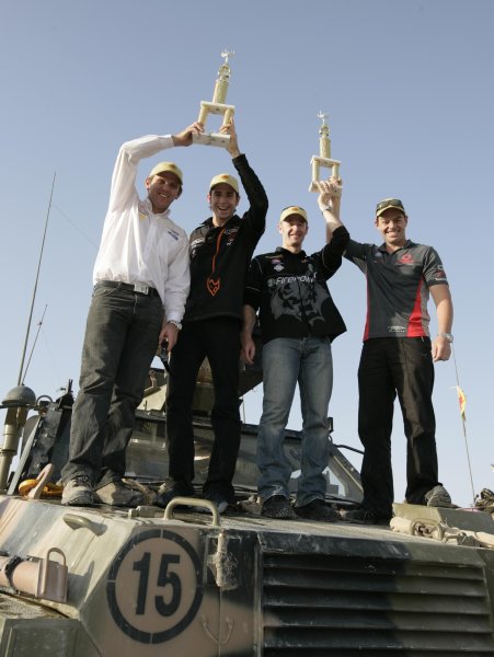 2007 Australian V8 Supercars.
Bahrain International Circuit. Sakhir, Bahrain.
2nd - 4th November. 
Greg Murphy and Rick Kelly  with Ford drivers Jason Bright and Craig Lowndes the inaugural Tallil  armored troop carrier race during a visit to the Australian troops based at Tallil Airbase located approximately 310 kilometers Southeast of Baghdad, Iraq.
World Copyright: Mark Horsburgh/LAT Photographic. 
Ref: Digital Image V8-Drivers-IRAQ-7507