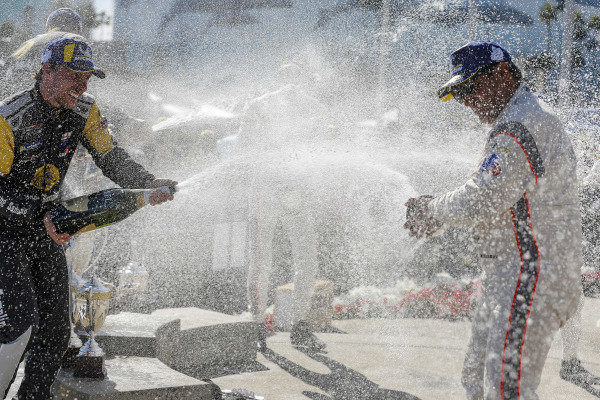 #5 Mustang Sampling Racing Cadillac DPi, DPi: Joao Barbosa, Filipe Albuquerque, #6 Acura Team Penske Acura DPi, DPi: Juan Pablo Montoya, Dane Cameron, #7 Acura Team Penske Acura DPi, DPi: Helio Castroneves, Ricky Taylor celebrate on the podium with champagne