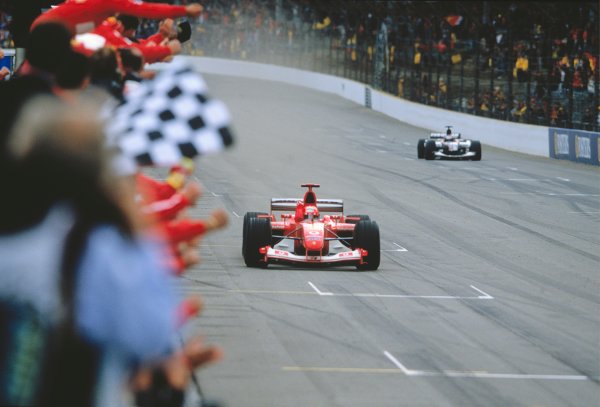 2003 United States Grand Prix
Indianapolis, USA. 26th - 28th October 2003
MICHAEL SCHUMACHER, FERRARI F2003 GA, winning. Chequered Flag. Action. Minardi
World Copyright: Charles Coates / LAT Photographic 
ref: 35mm Image 03AMER04